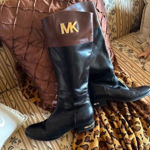 Brown and black MK boots with embossed gold “MK”